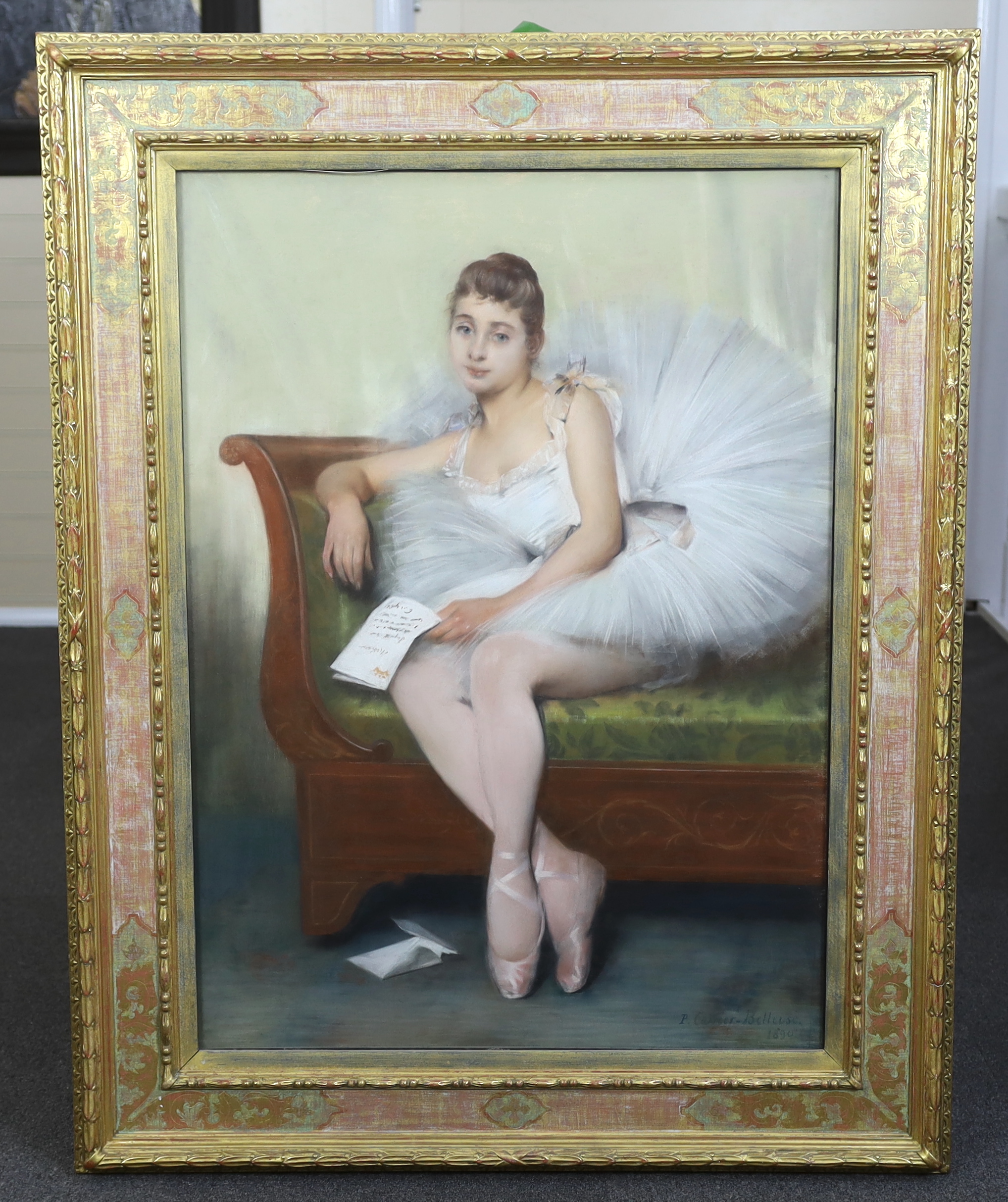 Pierre Carrier-Belleuse (French, 1851-1932), Portrait of a young ballerina seated upon a couch, holding a letter, pastel, 99 x 71cm